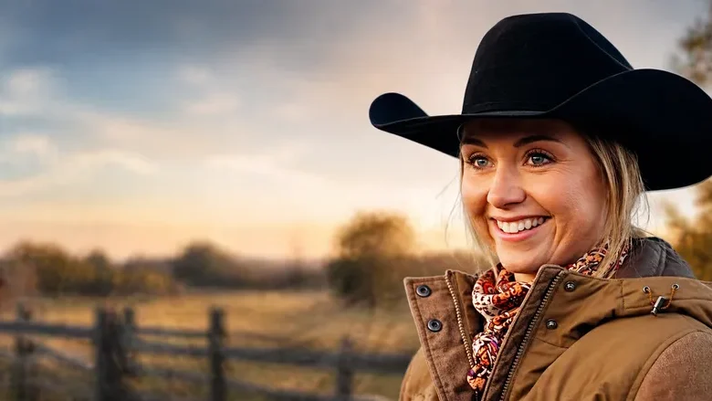 Amber Marshall as Amy Fleming standing on a ranch in Heartland, reflecting real-life connection to her role