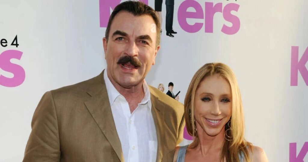Tom Selleck smiling alongside his wife Jillie Mack on the red carpet