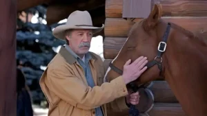 Shaun Johnston as Grandpa Jack standing beside his horse Paint in a quiet ranch setting