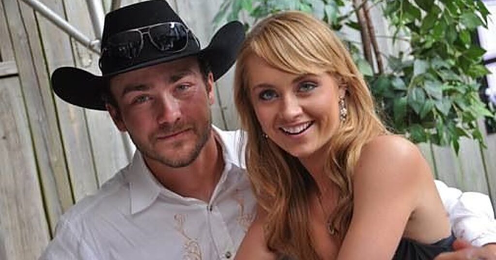 Heartland star Amber Marshall smiling beside her husband Shawn Turner, who wears a black cowboy hat
