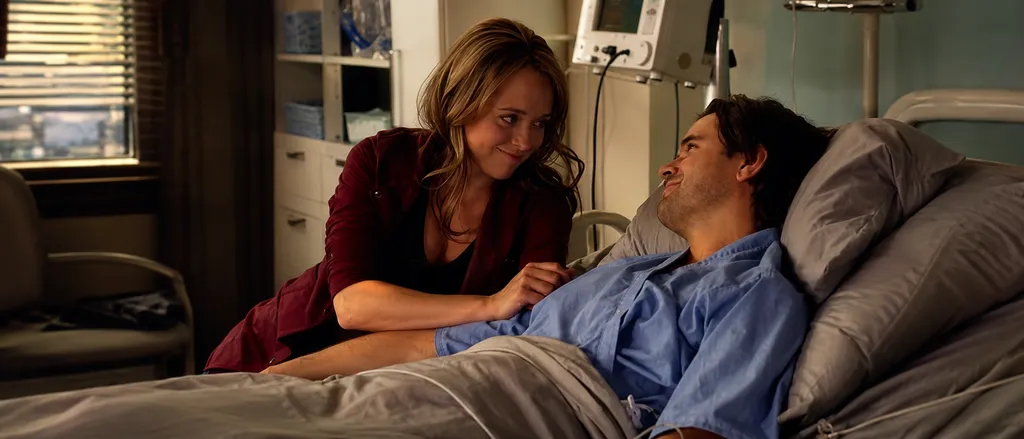 Amy Fleming sits beside Ty Borden in a Heartland hospital scene