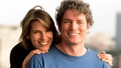 Christopher Reeve smiling in a wheelchair next to his wife Dana Reeve, both outdoors and happy