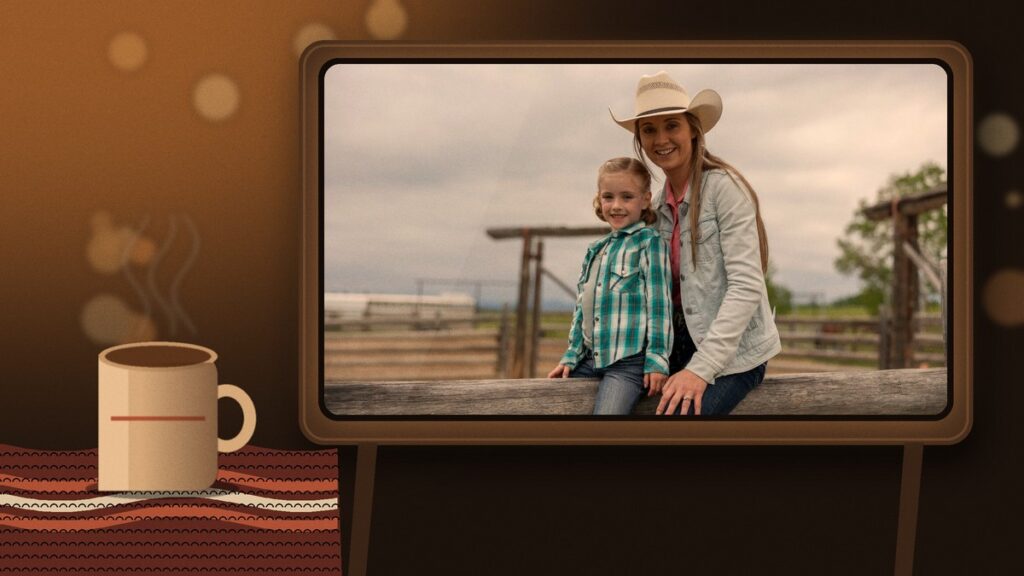 Amber Marshall as Amy Fleming smiling beside Lyndy on a ranch fence, shown on a glowing vintage TV in a cozy room with a mug of tea and a knit blanket