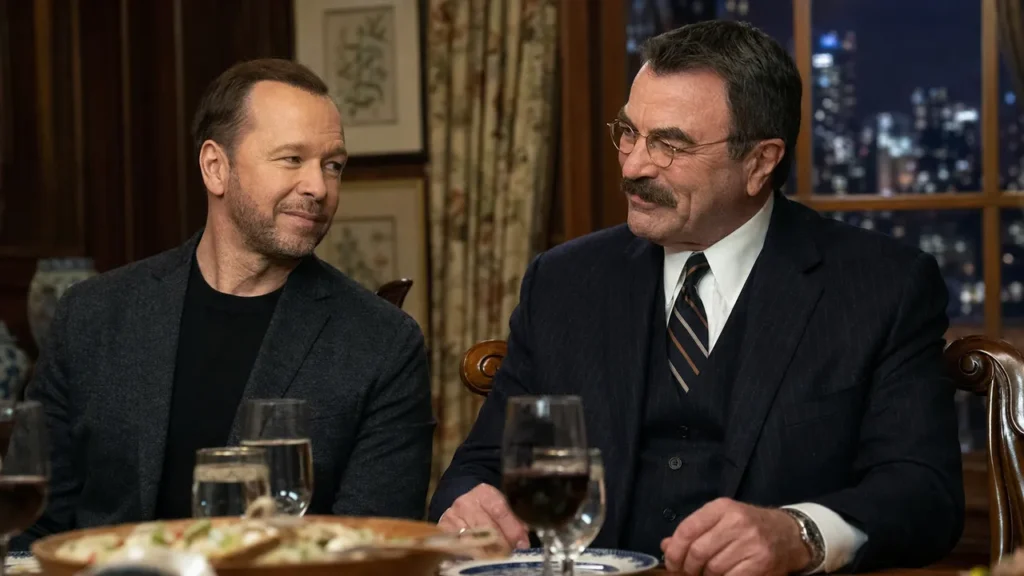 Donnie Wahlberg and Tom Selleck seated together at a family dinner table