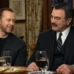 Donnie Wahlberg and Tom Selleck seated together at a family dinner table