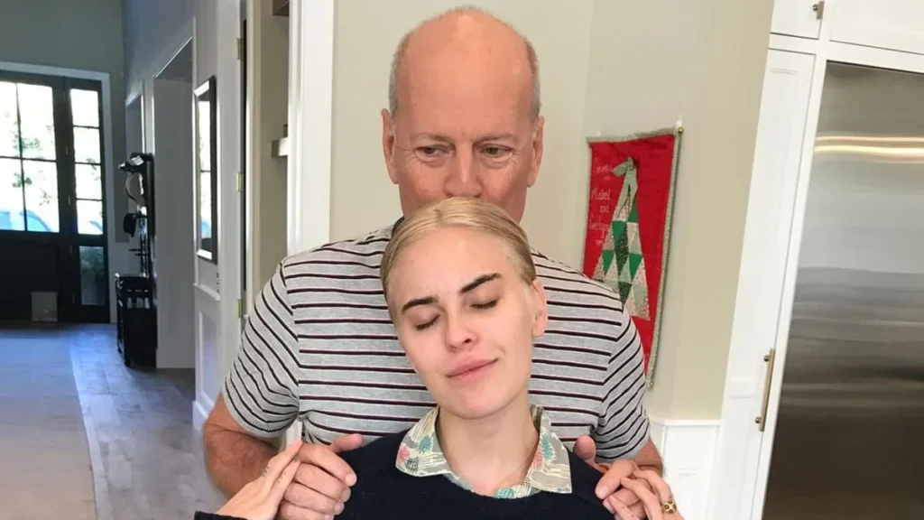 Bruce Willis stands closely with his daughter Tallulah Willis in a candid, personal moment away from the spotlight. The two share an intimate family connection in this quiet, unpolished photograph.