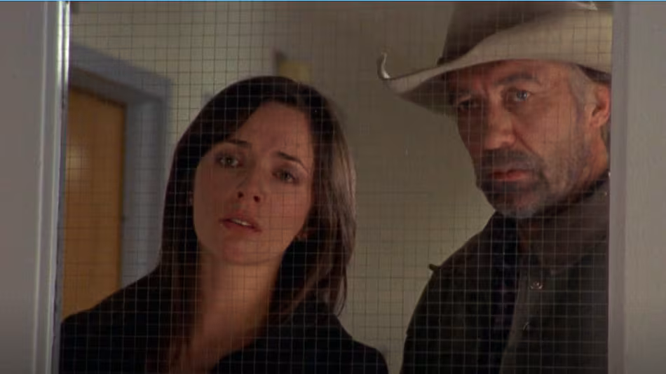Michelle Morgan as Lou and Shaun Johnston as Jack look through a hospital window in the first episode of Heartland